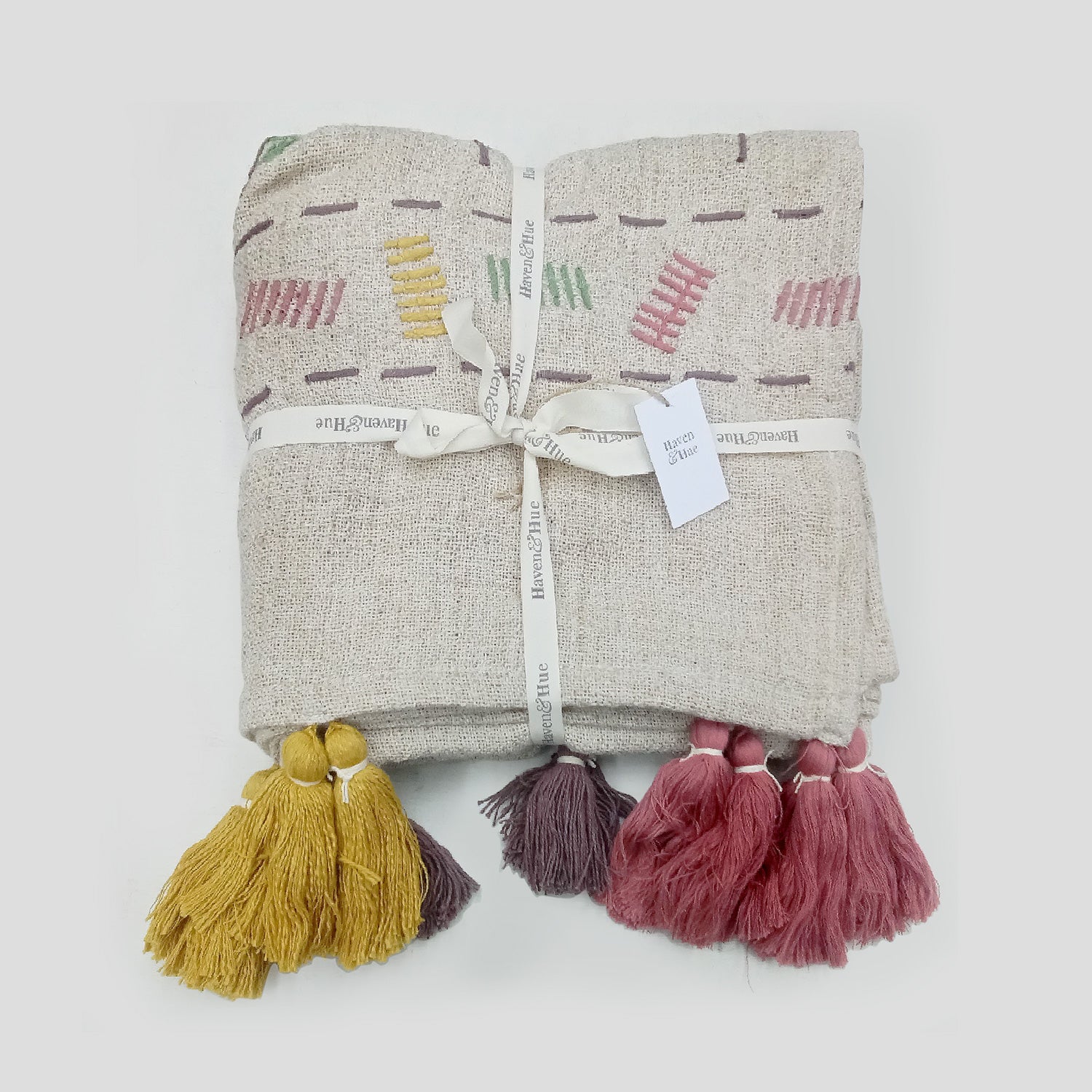 Folded Multi coloured 100% cotton woven throw with tassels & embroidery detail