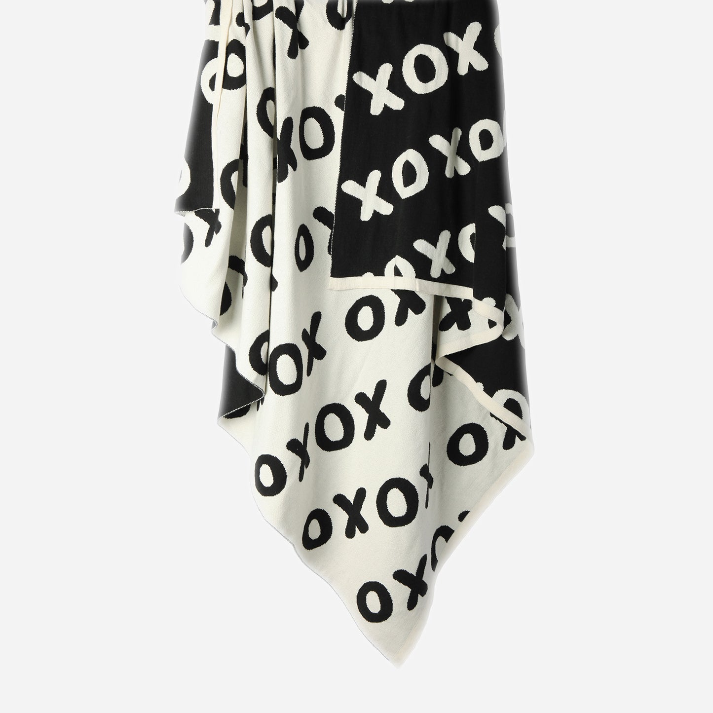 Hanging Noughts & Crosses 100% cotton knitted throw in white and black, showing white/light side