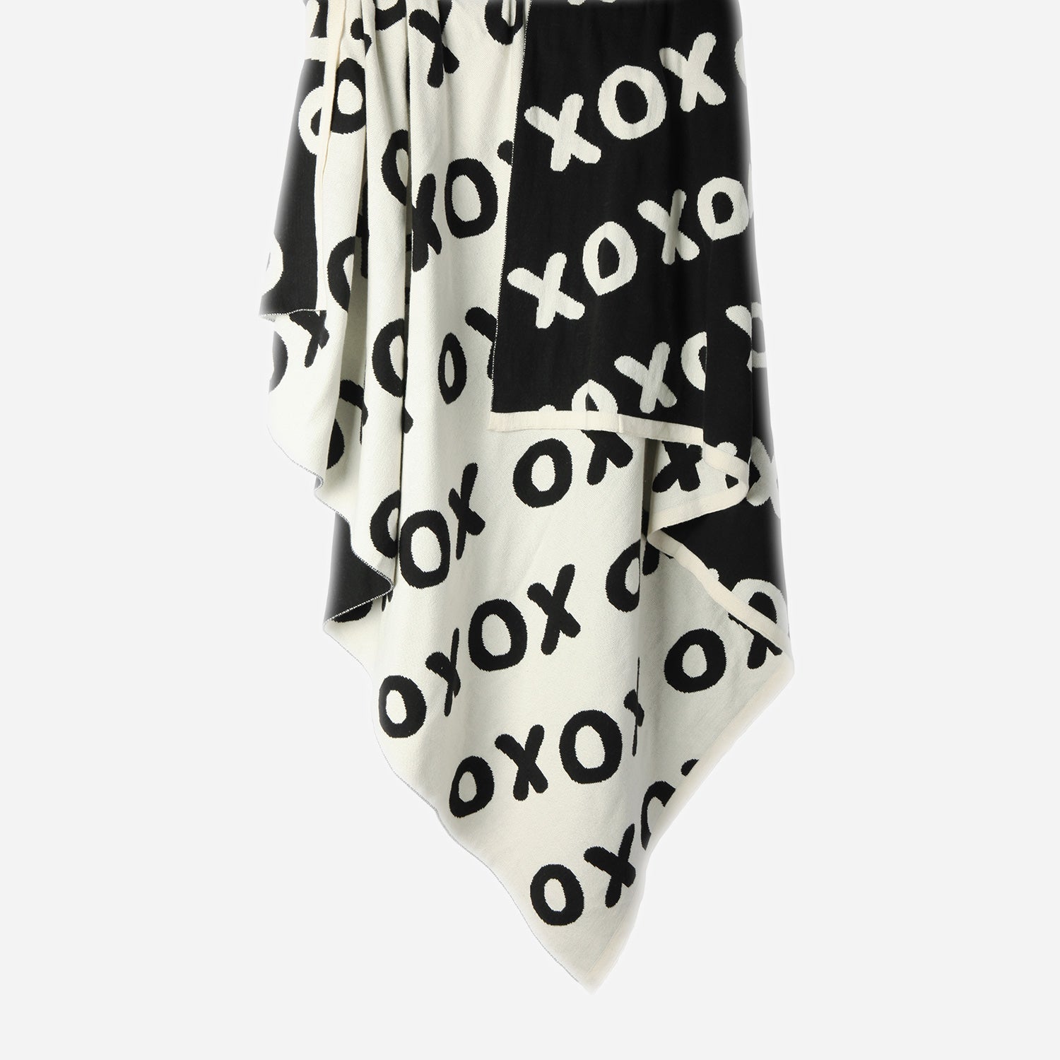 Hanging Noughts & Crosses 100% cotton knitted throw in white and black, showing white/light side