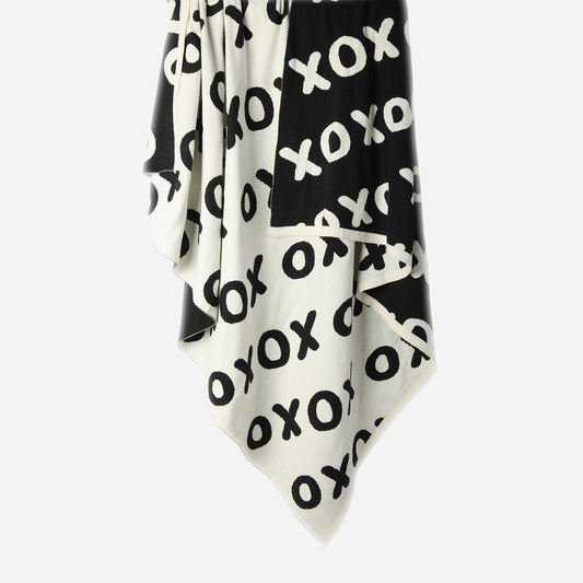 Hanging Noughts & Crosses 100% cotton knitted throw in white and black, showing white/light side