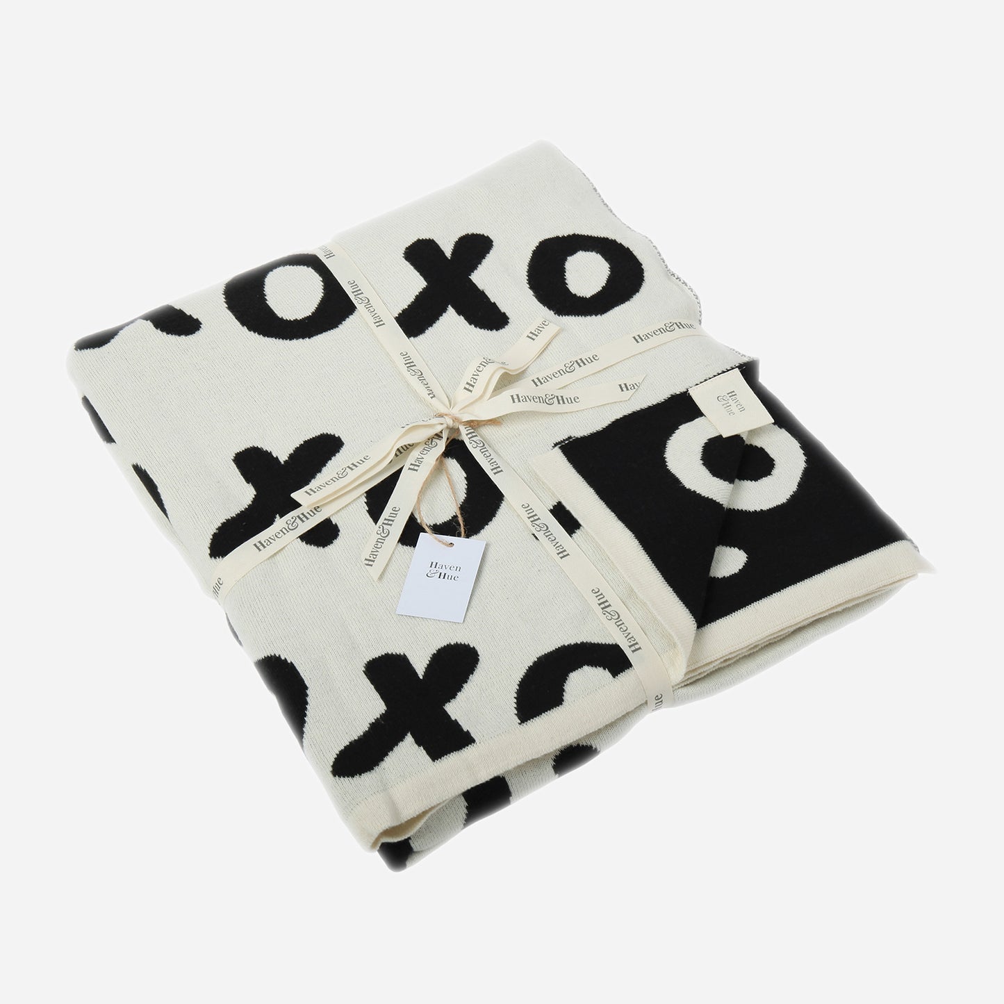 Folded Noughts & Crosses 100% cotton knitted throw in white and black with ribbon detail