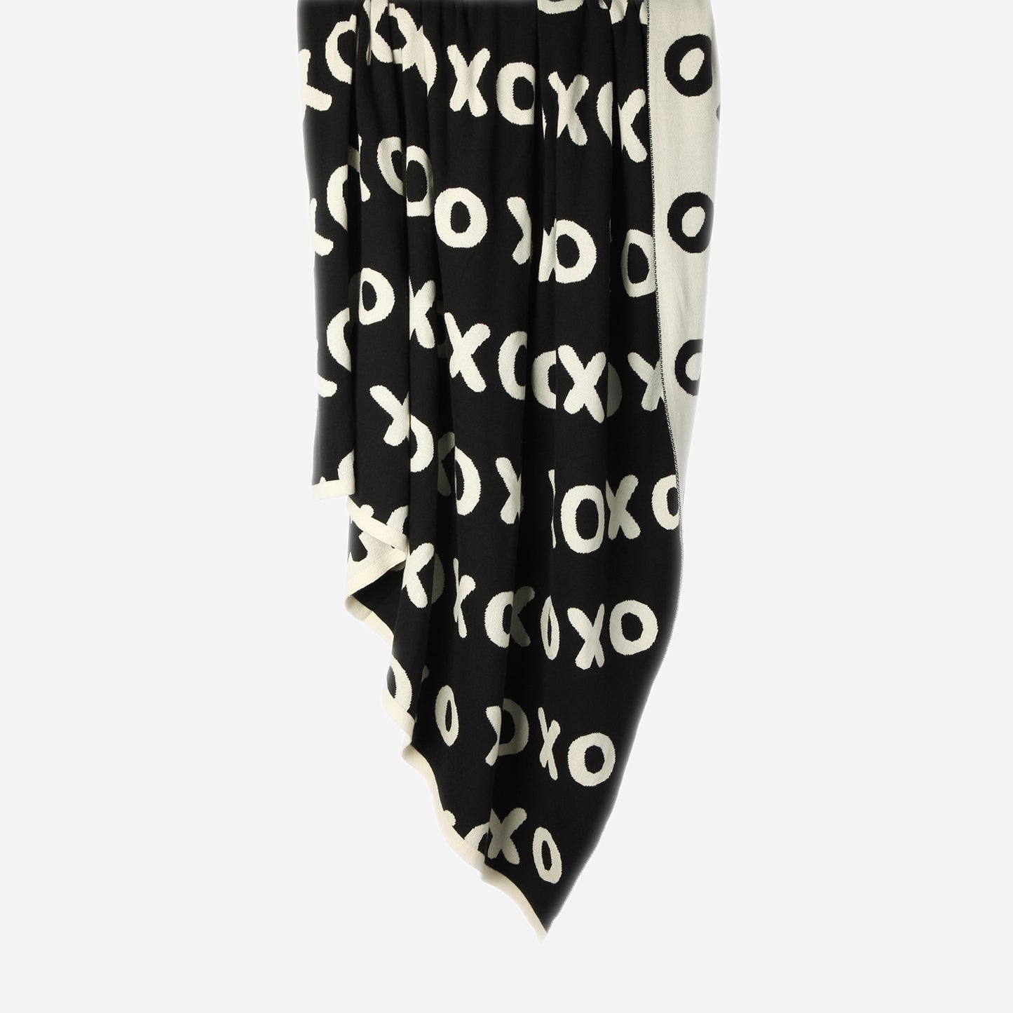 Hanging Noughts & Crosses 100% cotton knitted throw in white and black, showing black/dark side