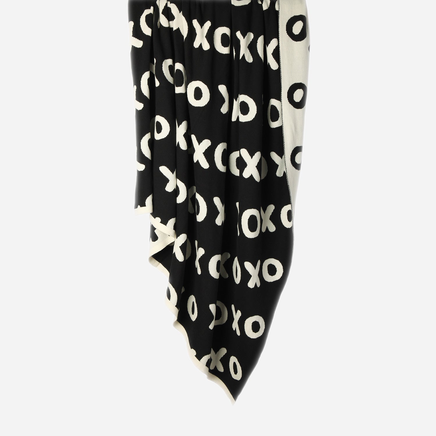 Hanging Noughts & Crosses 100% cotton knitted throw in white and black, showing black/dark side